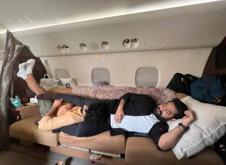 Tired Karthikeya and NTR sleeping in flight