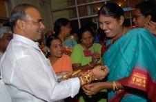 Women Ministers and Children tying Rakhis to CM