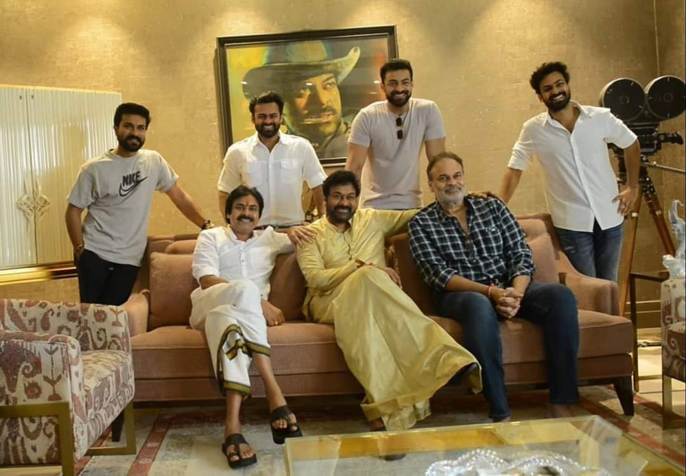 Flanked by Pawan and Naga Babu, Chiranjeevi cuts B-Day cake