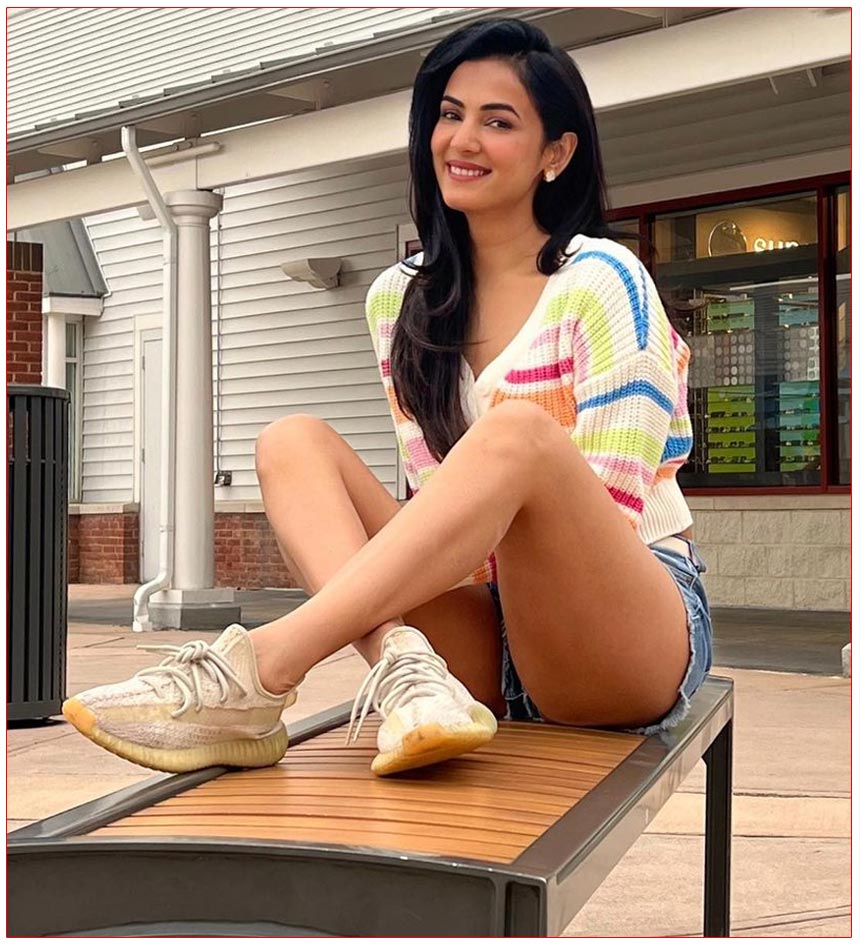 Sonal Chauhan Dressed in a vibrant rainbow mini top paired with blue denim