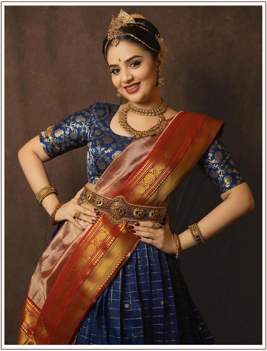 Sreemukhi donned a vibrant blue and red pattu half saree